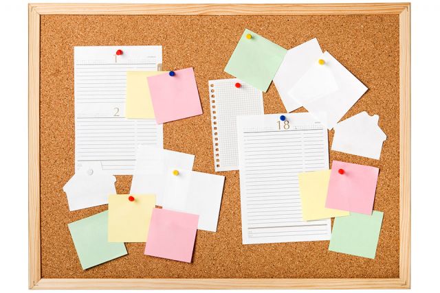 pin board covered in notices